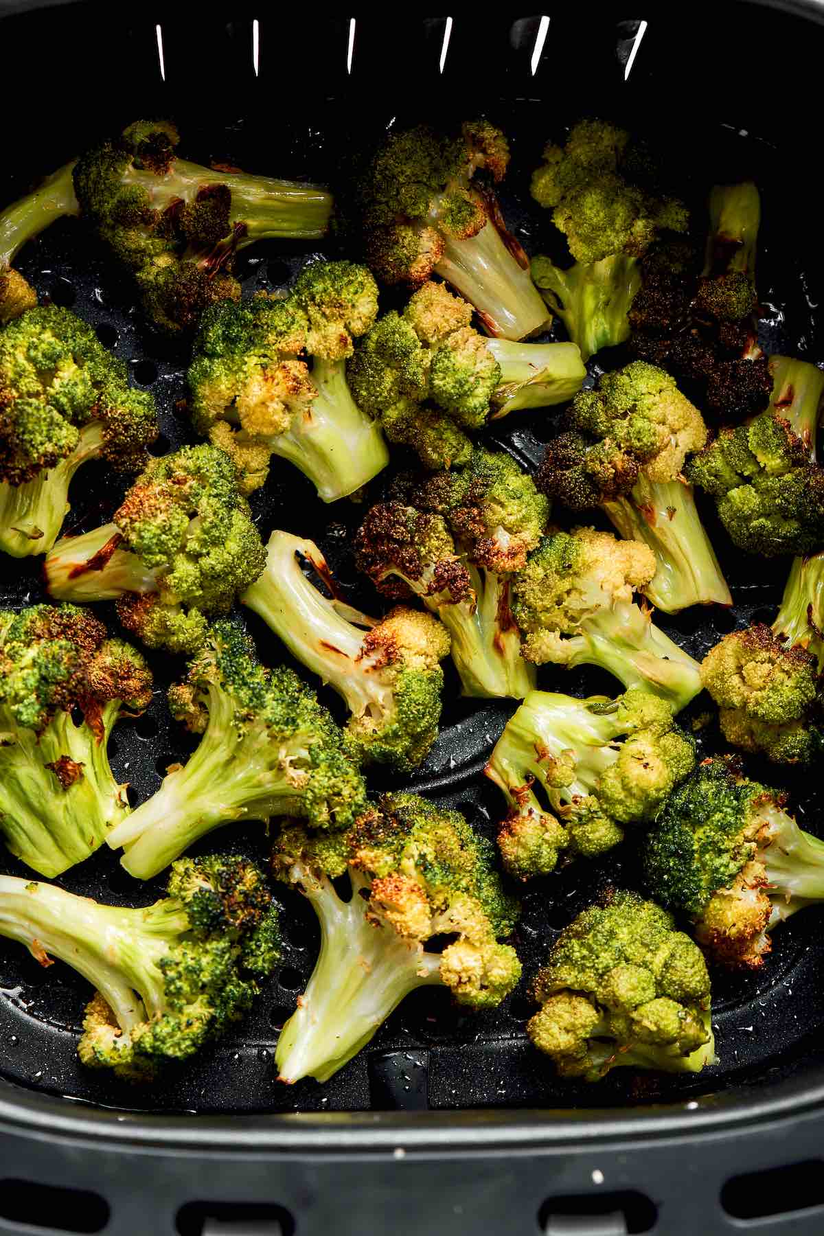 air fryer broccoli in the air fryer basket.