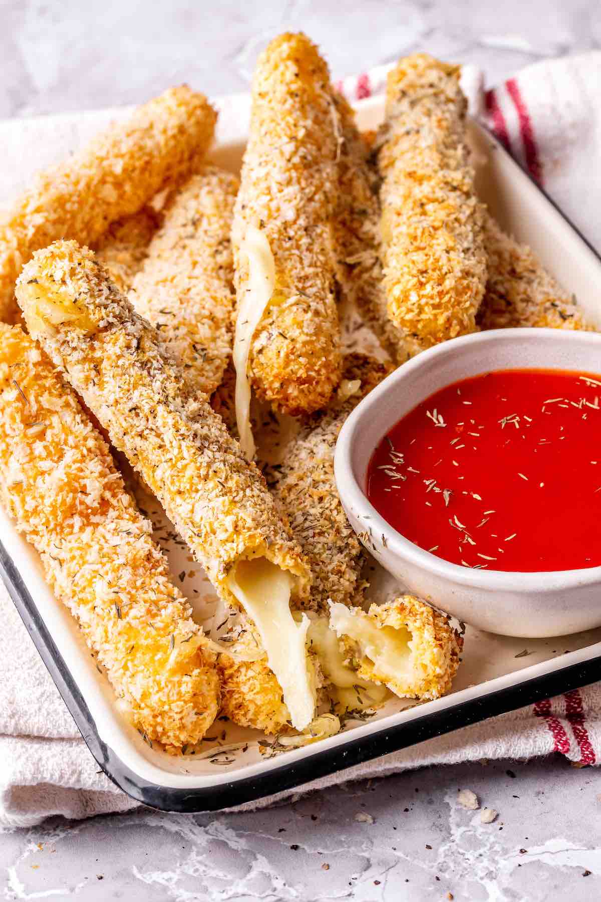 air fryer mozzarella sticks with marinara dipping sauce.