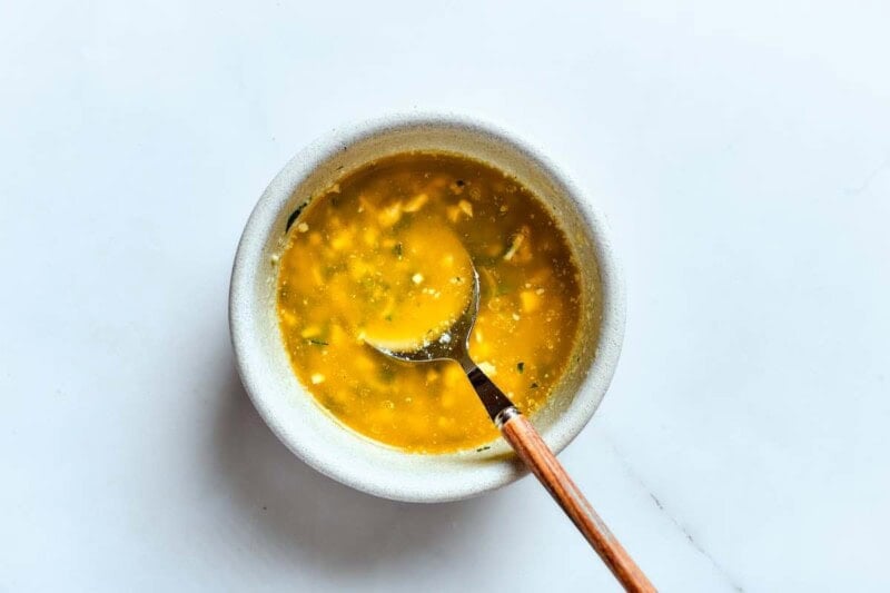 garlic, butter, and fresh herbs mixed in a bowl.