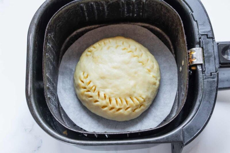 shaped uncooked bread in the air fryer.