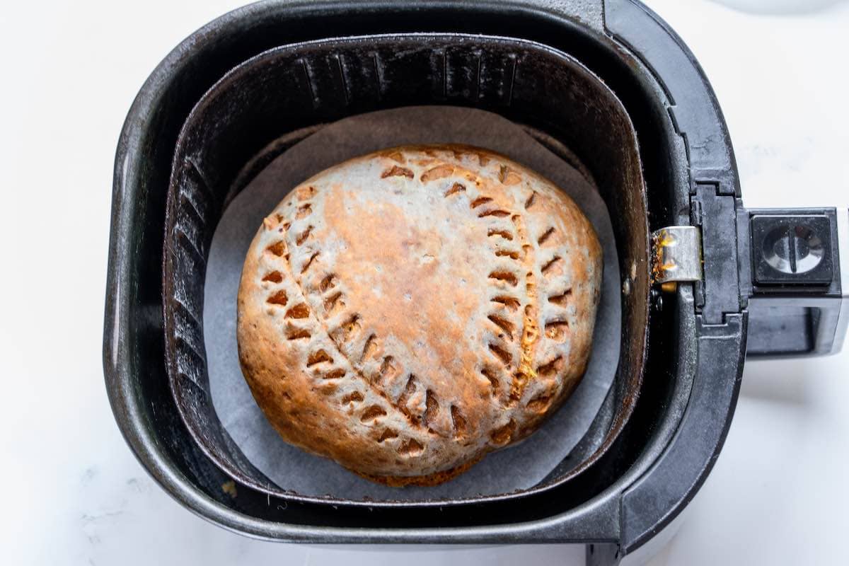 freshly baked air fryer bread in the air fryer basket.