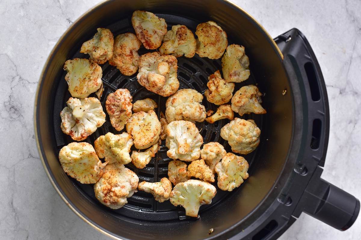 raw seasoned cauliflower in the air fryer.