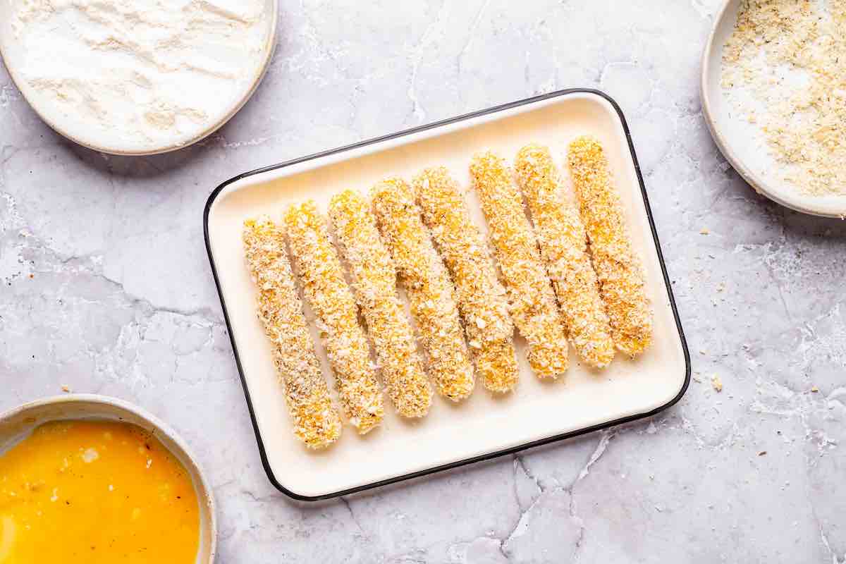 breaded mozzarella sticks on a plate.