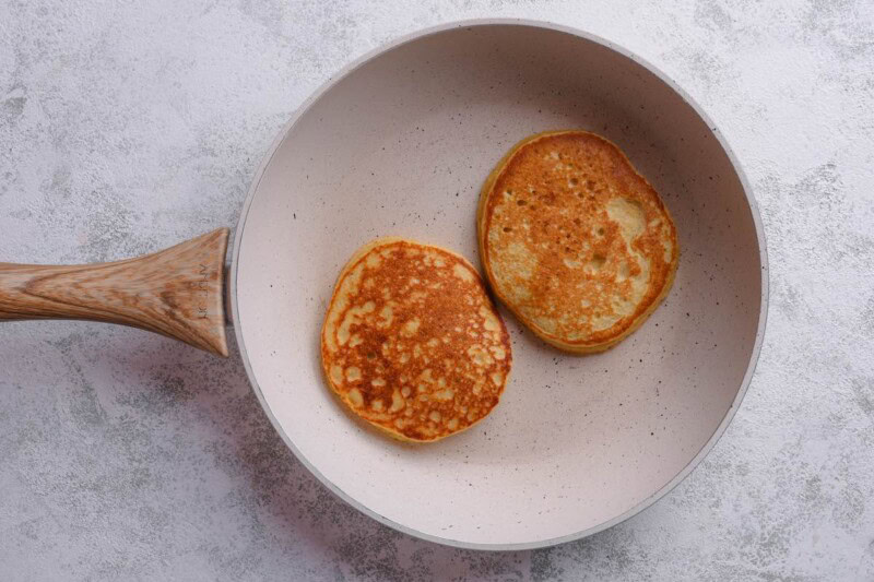 banana protein pancakes in a skillet.