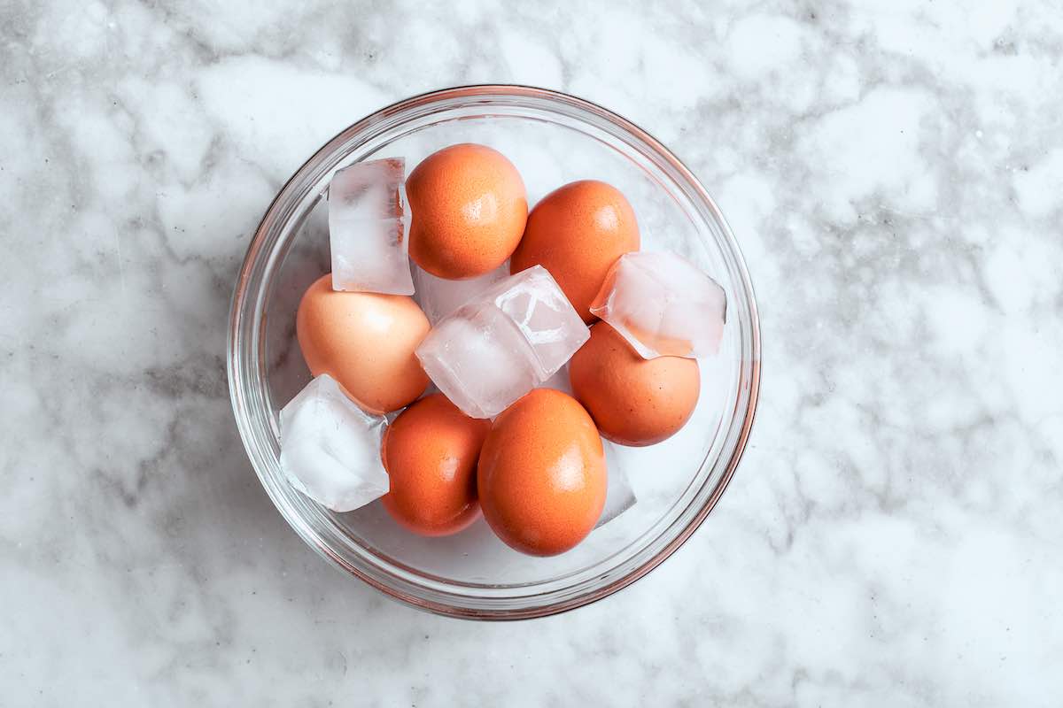 cooked eggs in a bowl with ice.