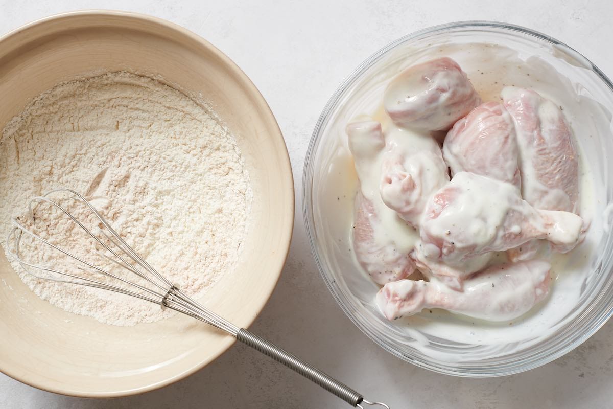 raw chicken pieces marinating in buttermilk.