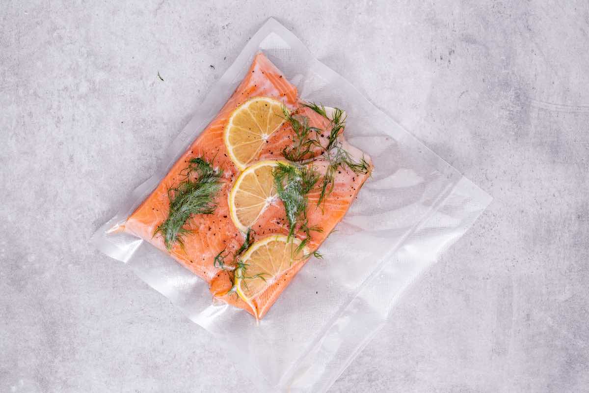 raw salmon, lemon slices, and dill in a ziplock bag.