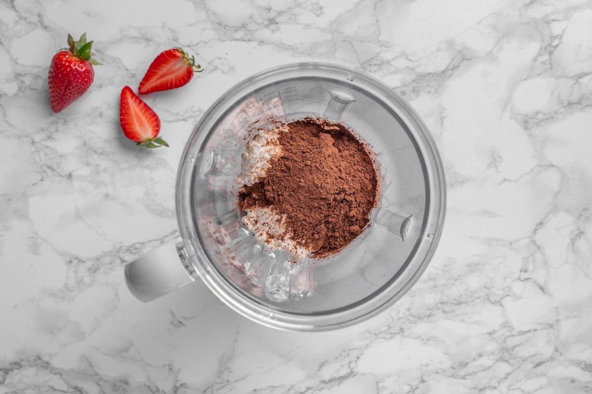 cocoa powder, maple syrup, and cottage cheese in a blender.