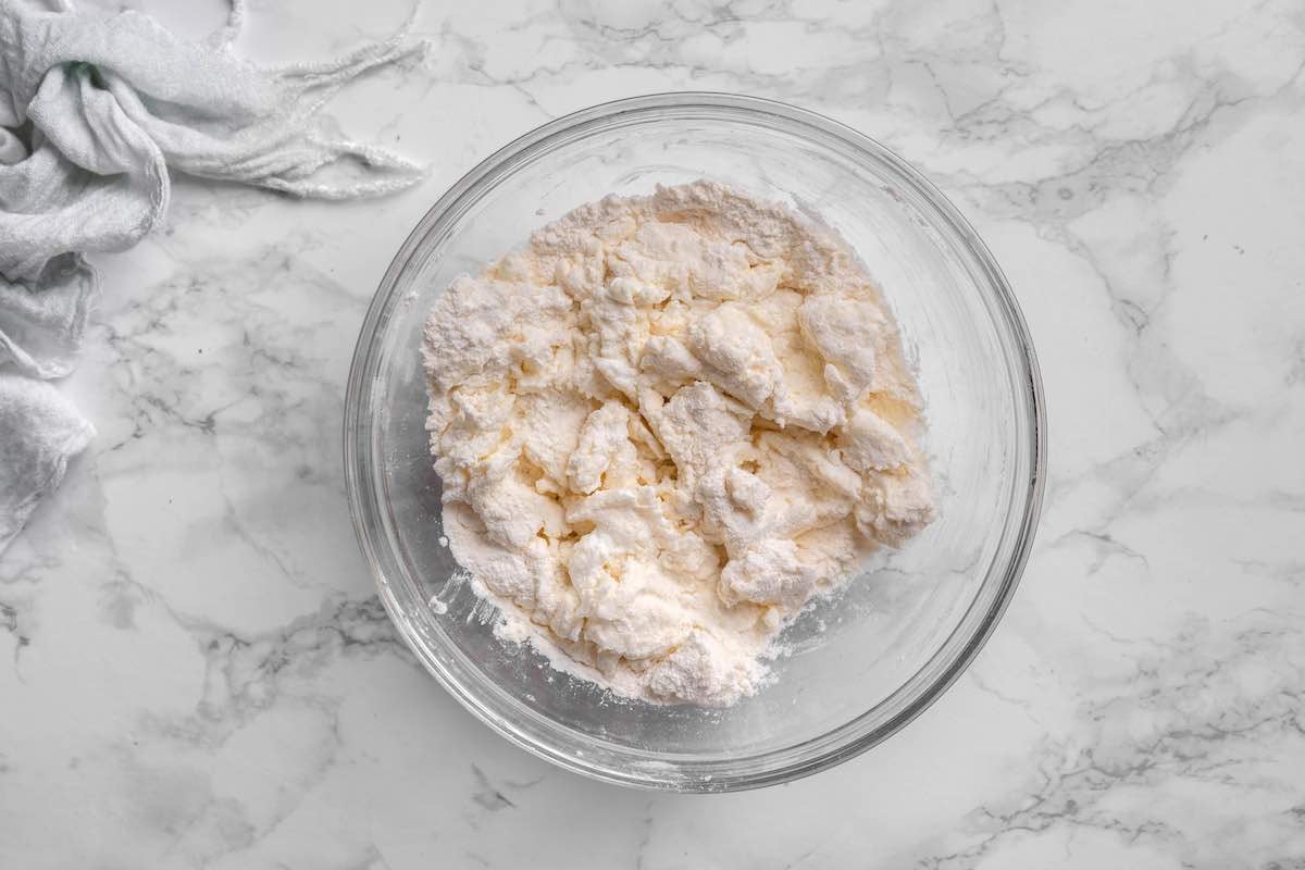 flour and whipped cottage cheese in a bowl.