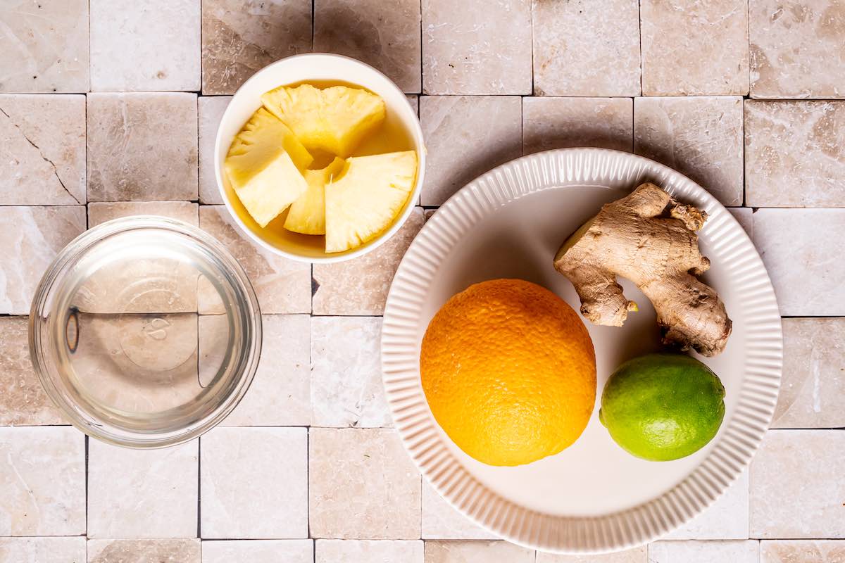 pineapple, orange, lime, and ginger on plates.