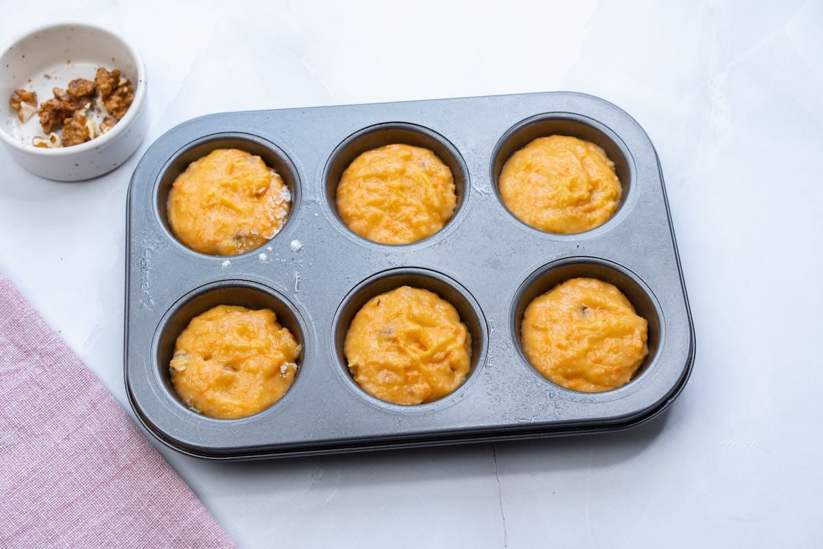 muffin batter in a muffin tin.