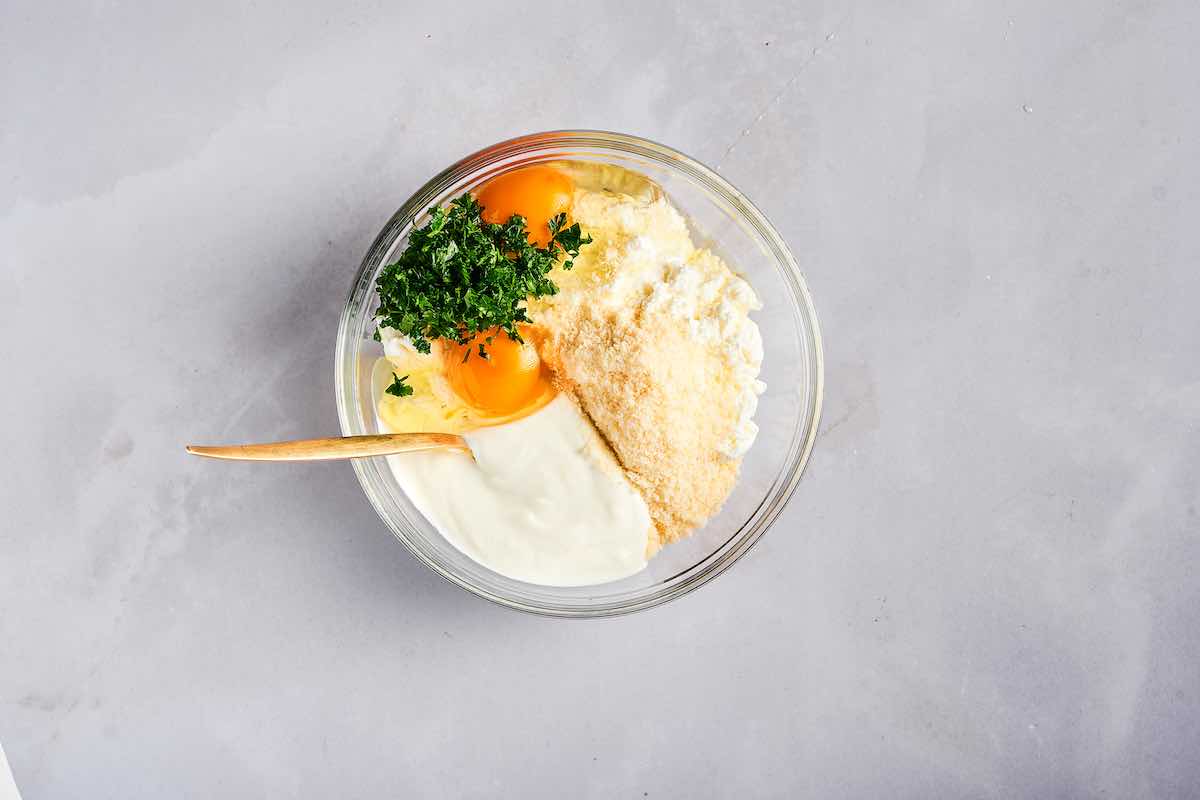 Greek yogurt, eggs, cheese, and cottage cheese in a bowl.