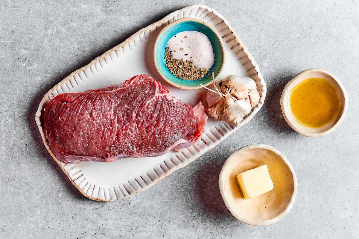 salt and pepper seasoned raw steak.