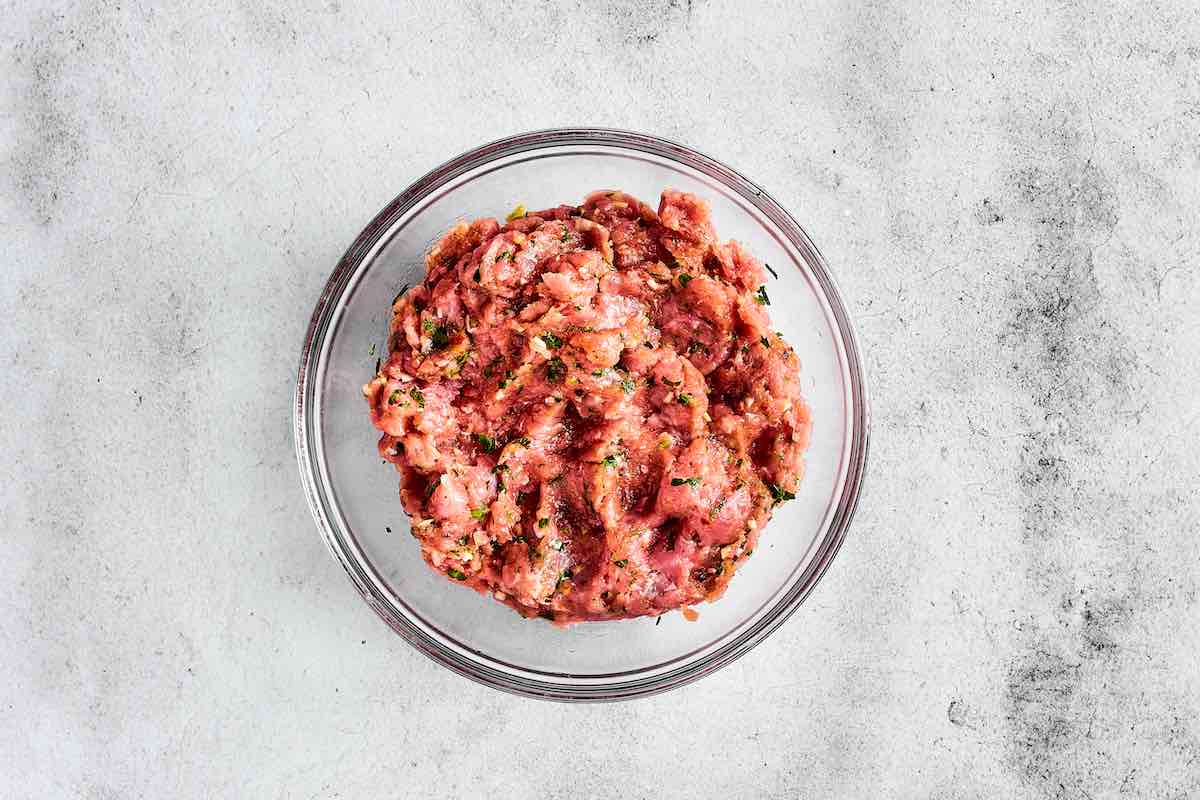 turkey burger mixture in a glass mixing bowl.