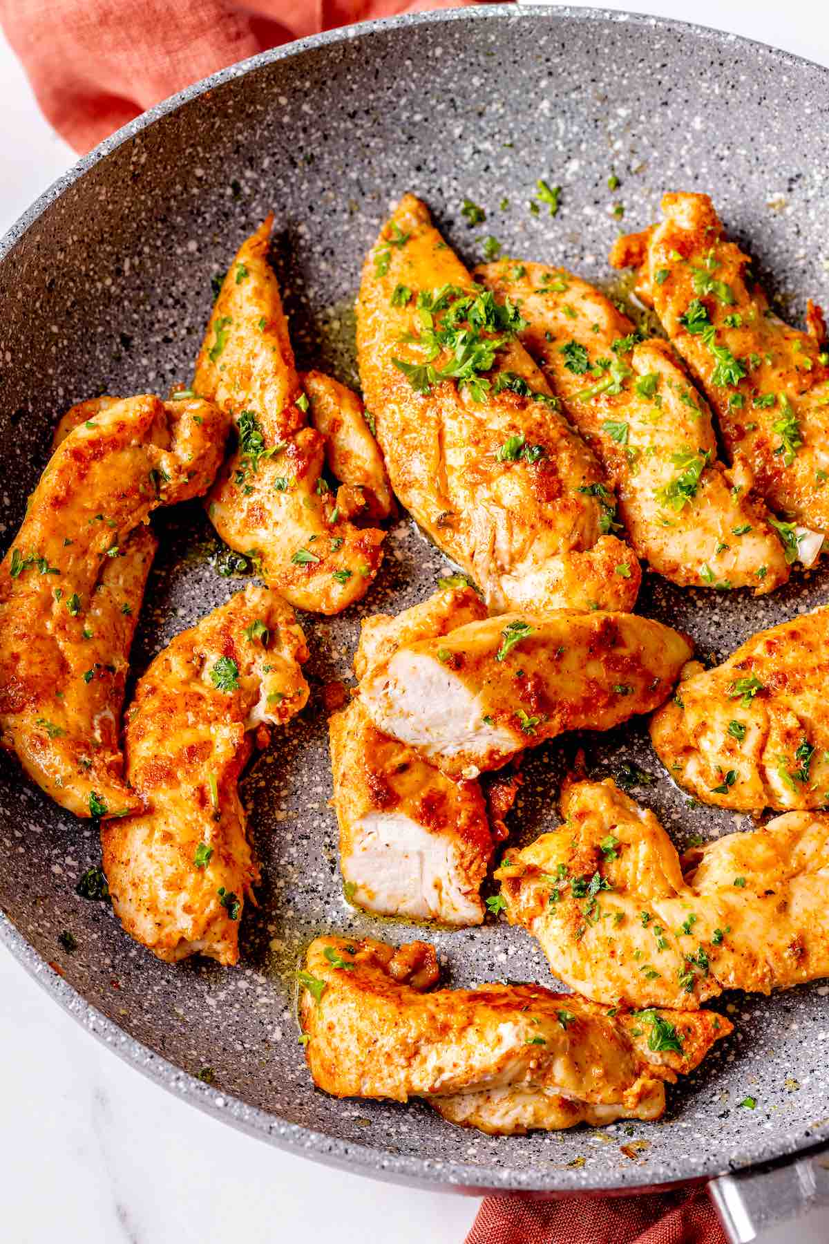 chicken tenderloins in a skillet.