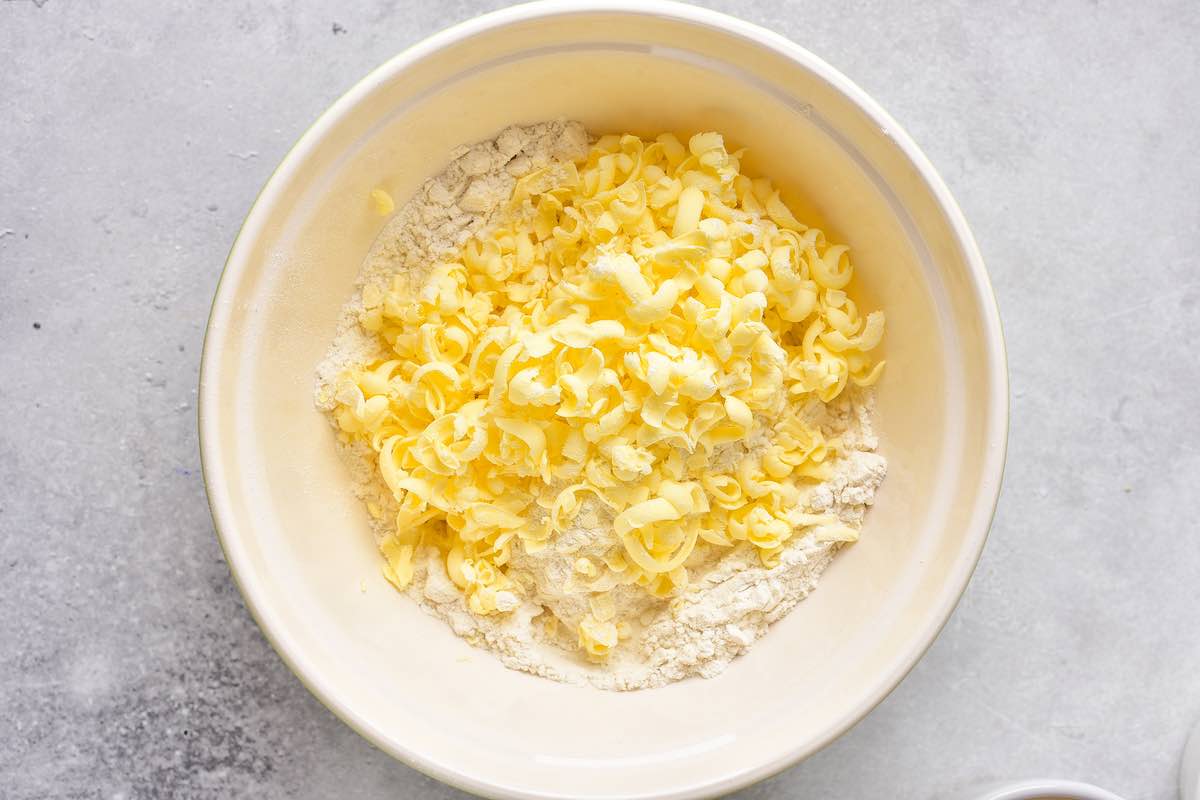 grated butter and flour in a bowl.