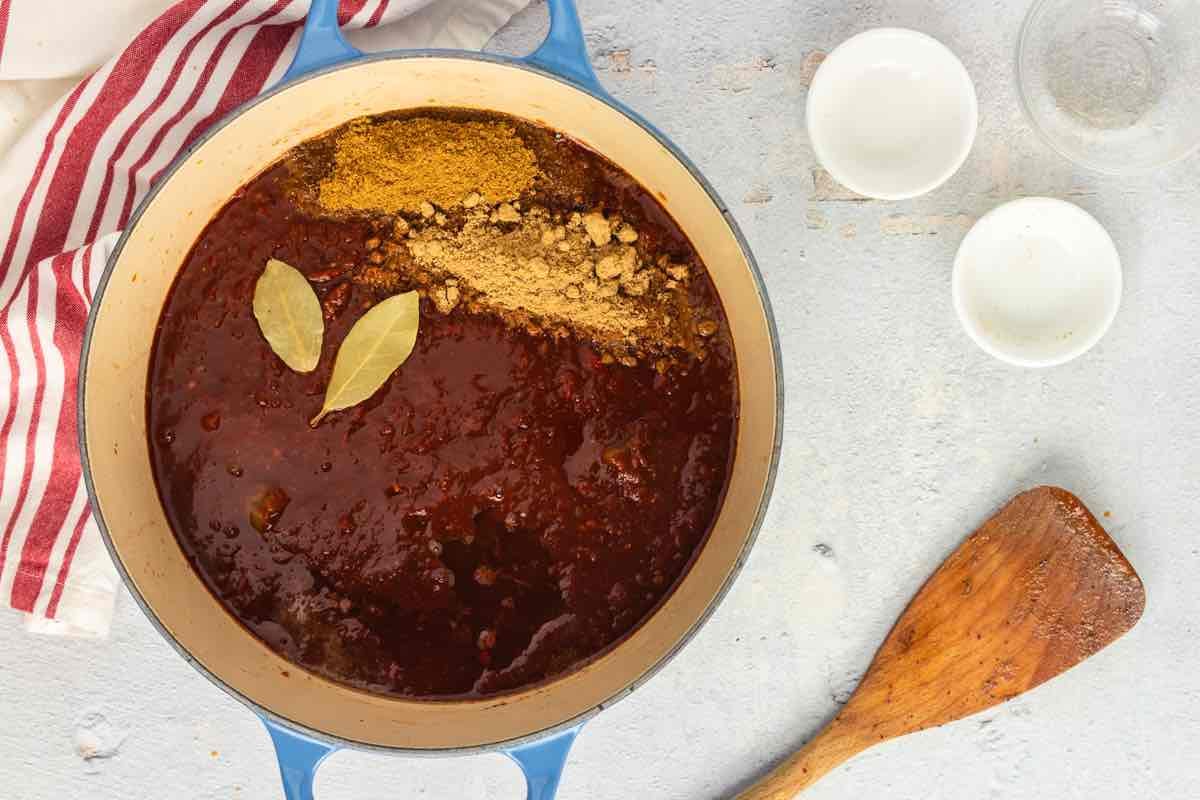 broth in a Dutch oven with seasonings.