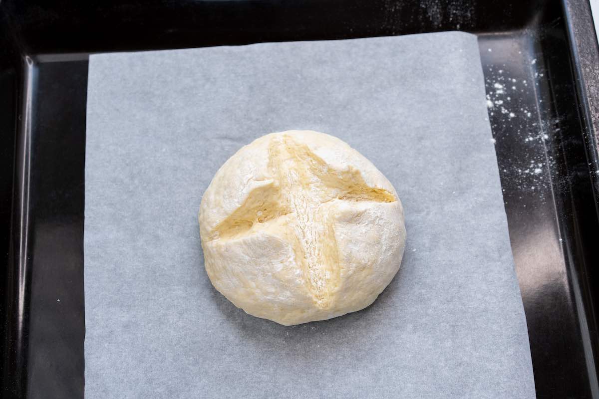 shaped scored ball of dough onto a baking sheet.