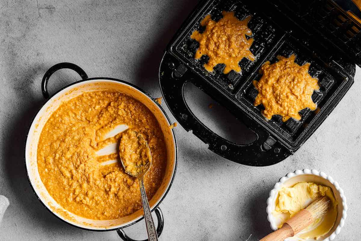 cooking waffles in the waffle iron.