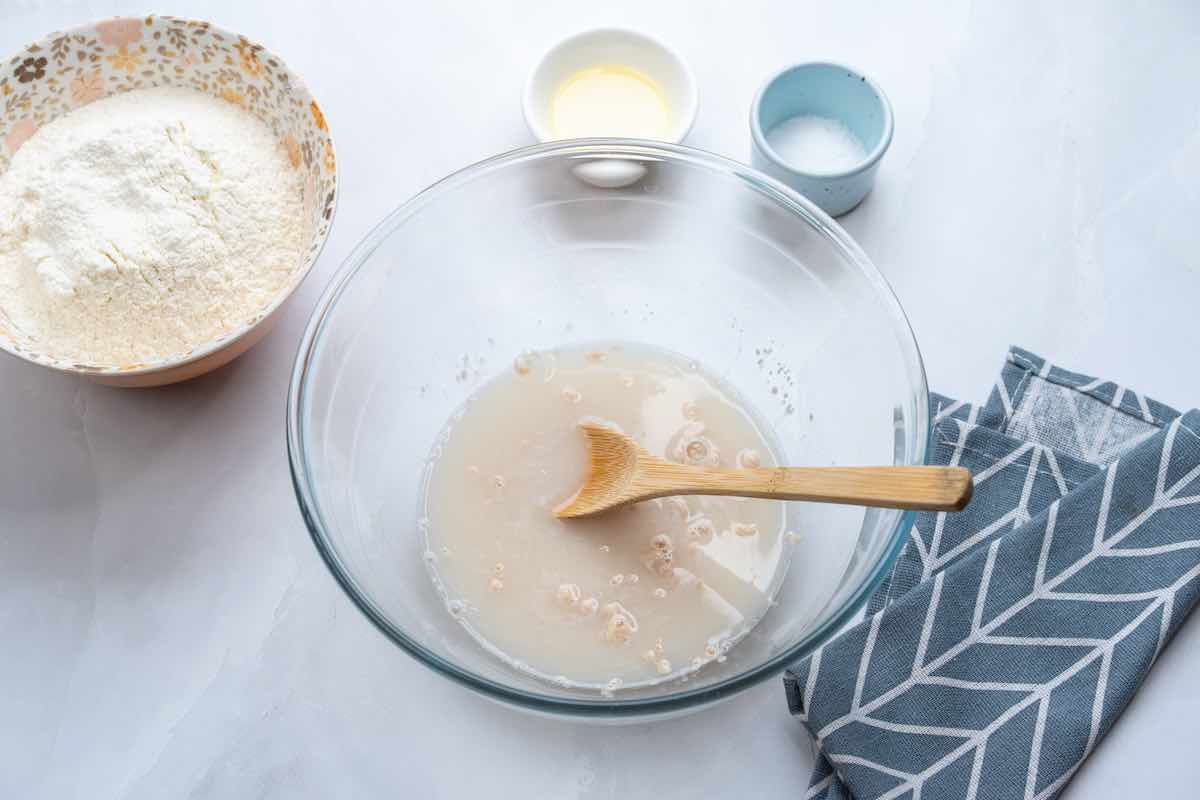 yeast being activated in the bowl with water.