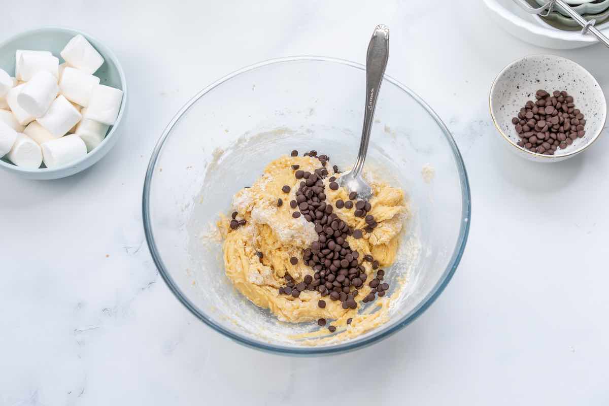 cookie dough with chocolate chips being mixed in.