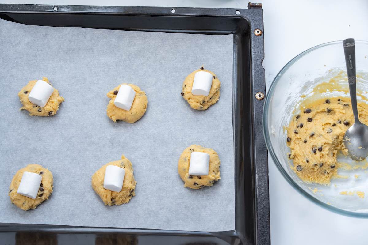 shaped unbaked cookies with a marshmallow on top.
