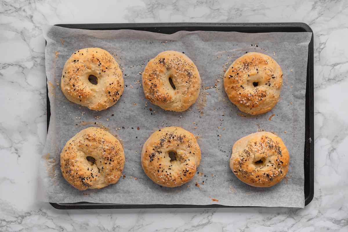 baked protein bagels on a baking sheet.