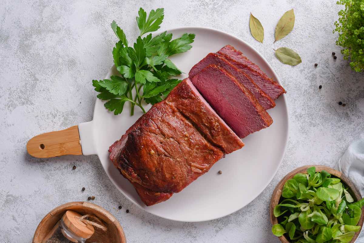 sliced cooked corned beef on a plate.