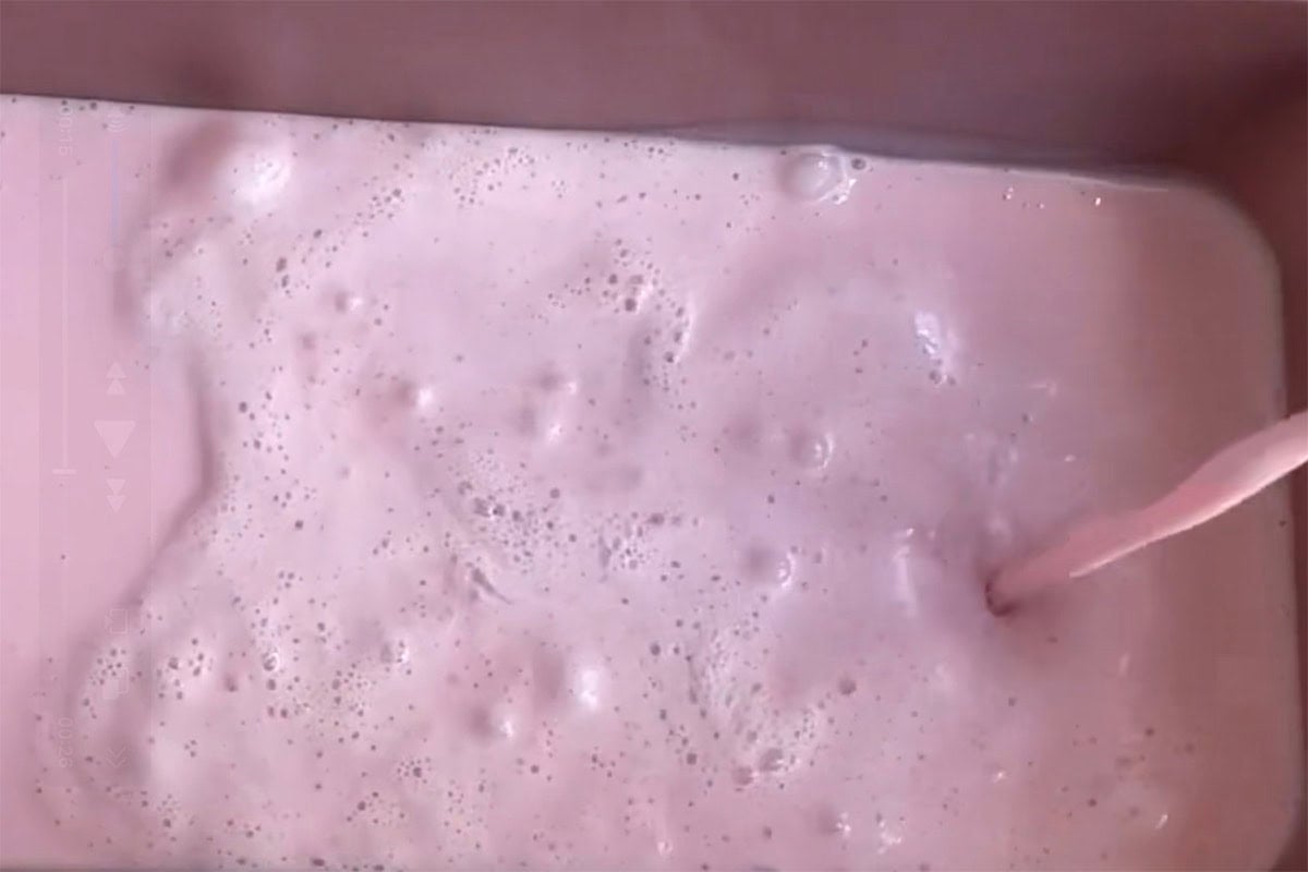 strawberry ice cream mixture in loaf pan.