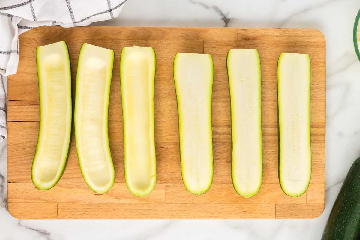 hollowing out halved zucchini.