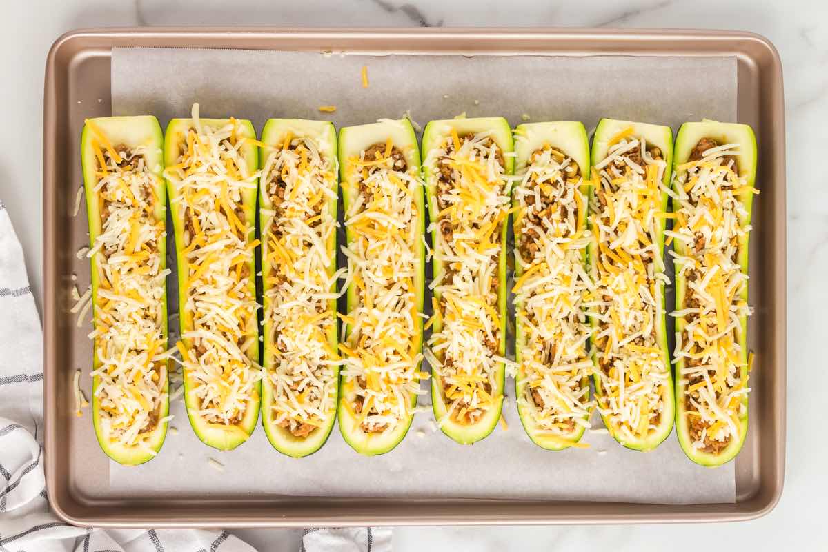 cheese sprinkled on top of the zucchini boats.