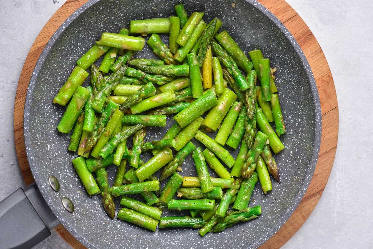 seasoned asparagus in a skillet.