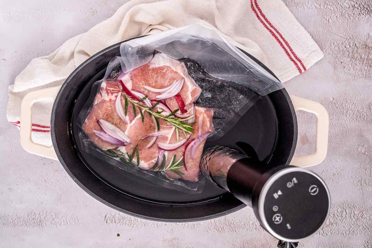 vacuum sealed pork chops in sous vide machine.