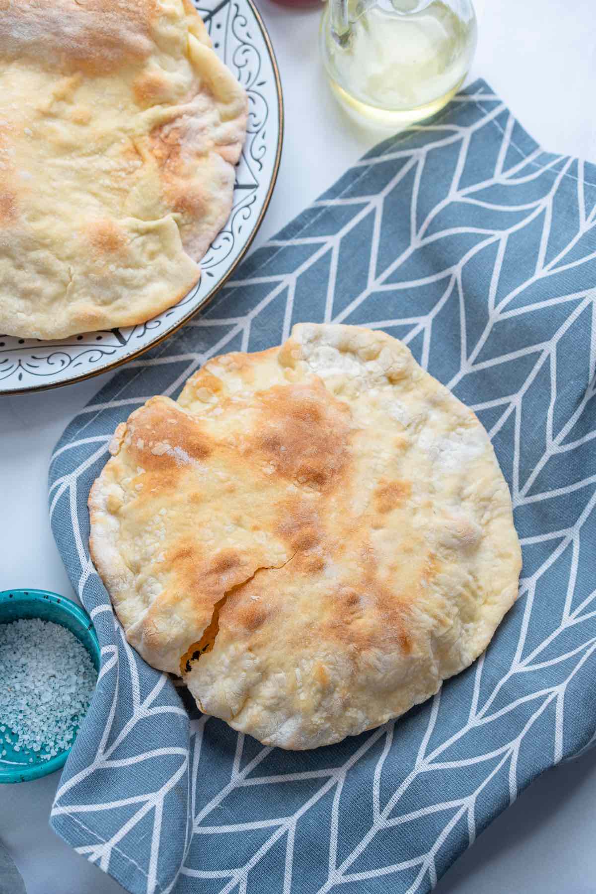 Lebanese pita bread on a dish towel.