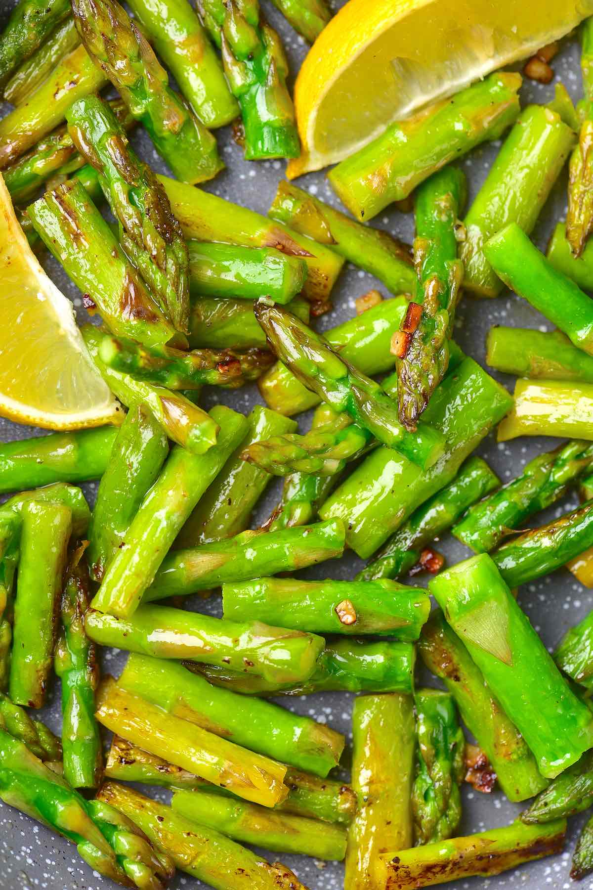 sauteed asparagus in a skillet.