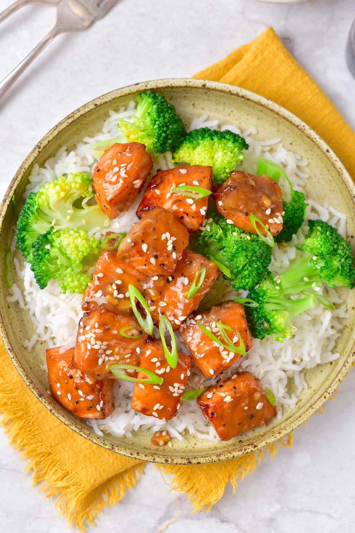 air fried salmon bites in a bowl with steamed broccoli.