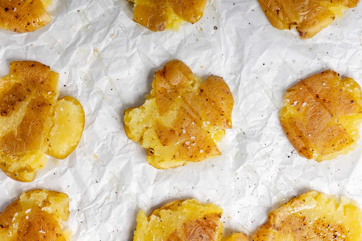 boiled potatoes smashed on a baking sheet.