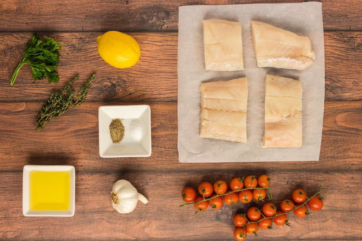raw haddock fillets on a baking sheet.