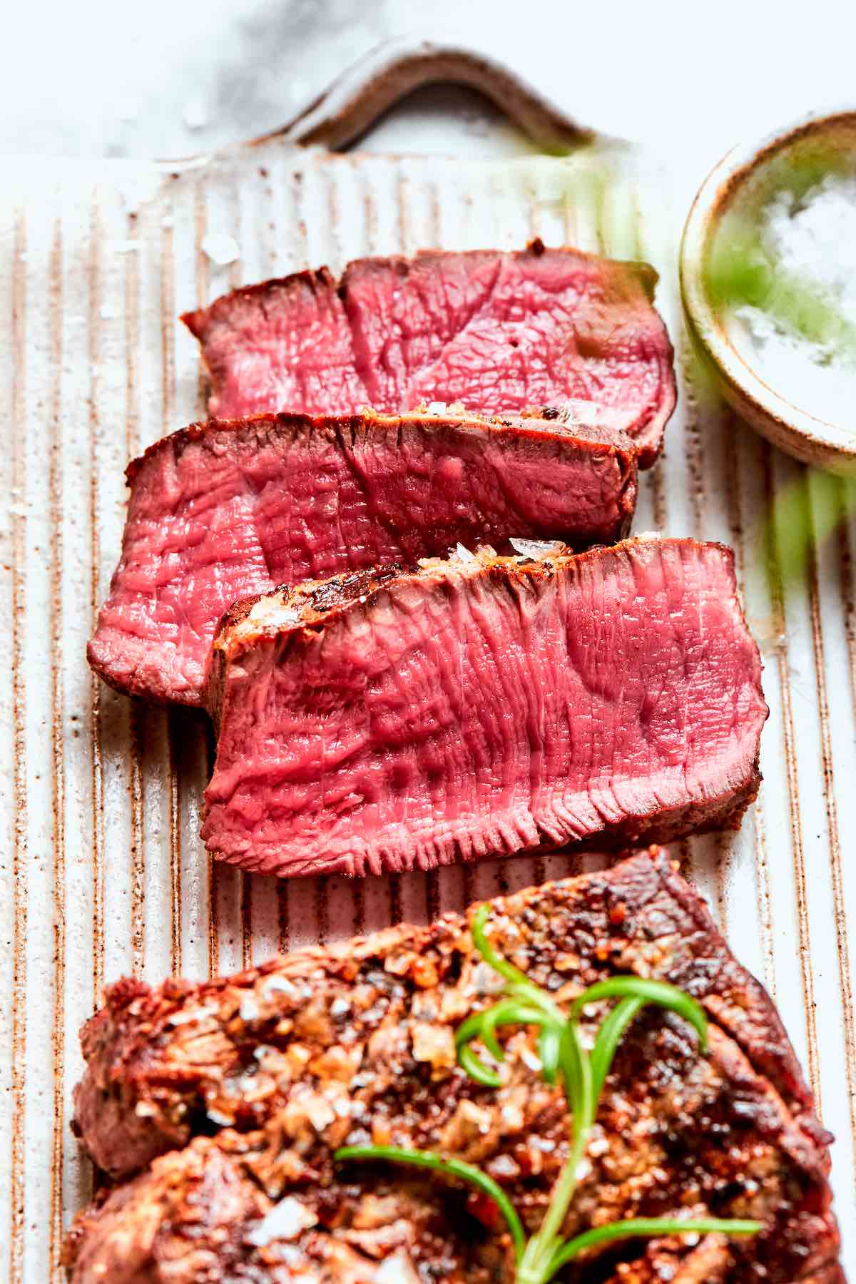 black and blue steak with coarse salt on top.