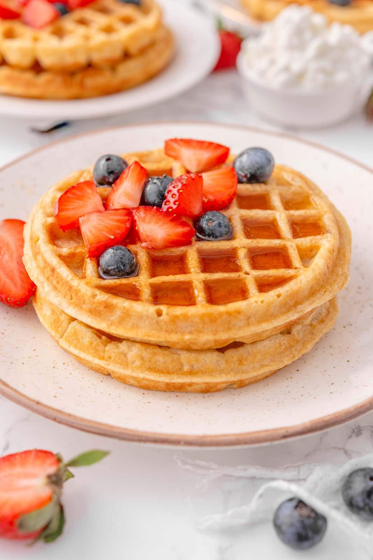 cottage cheese waffles with maple syrup with fresh berries.