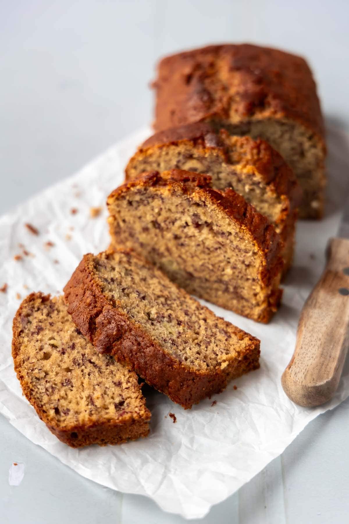 eggless banana bread sliced on parchment paper.