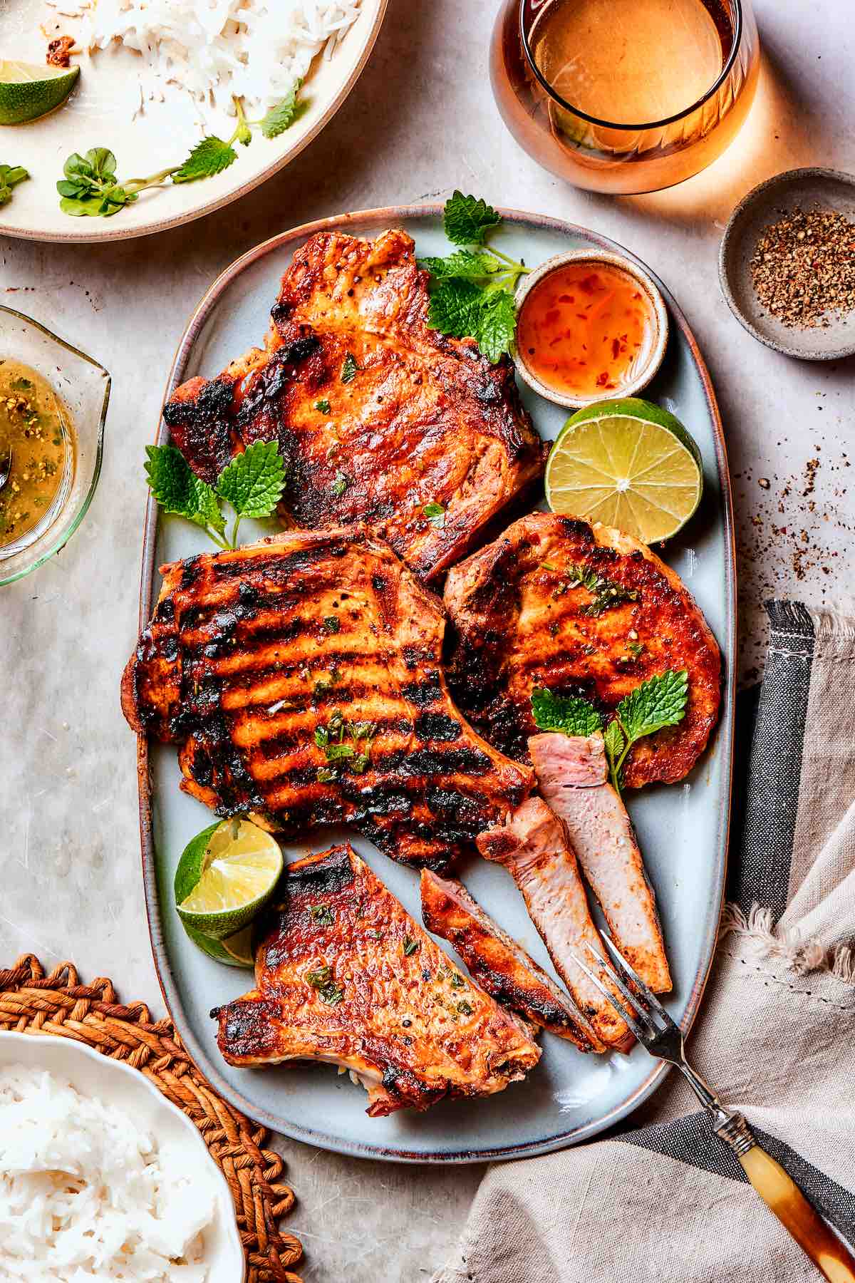 grilled boneless pork chops with fresh limes and sweet chili sauce.