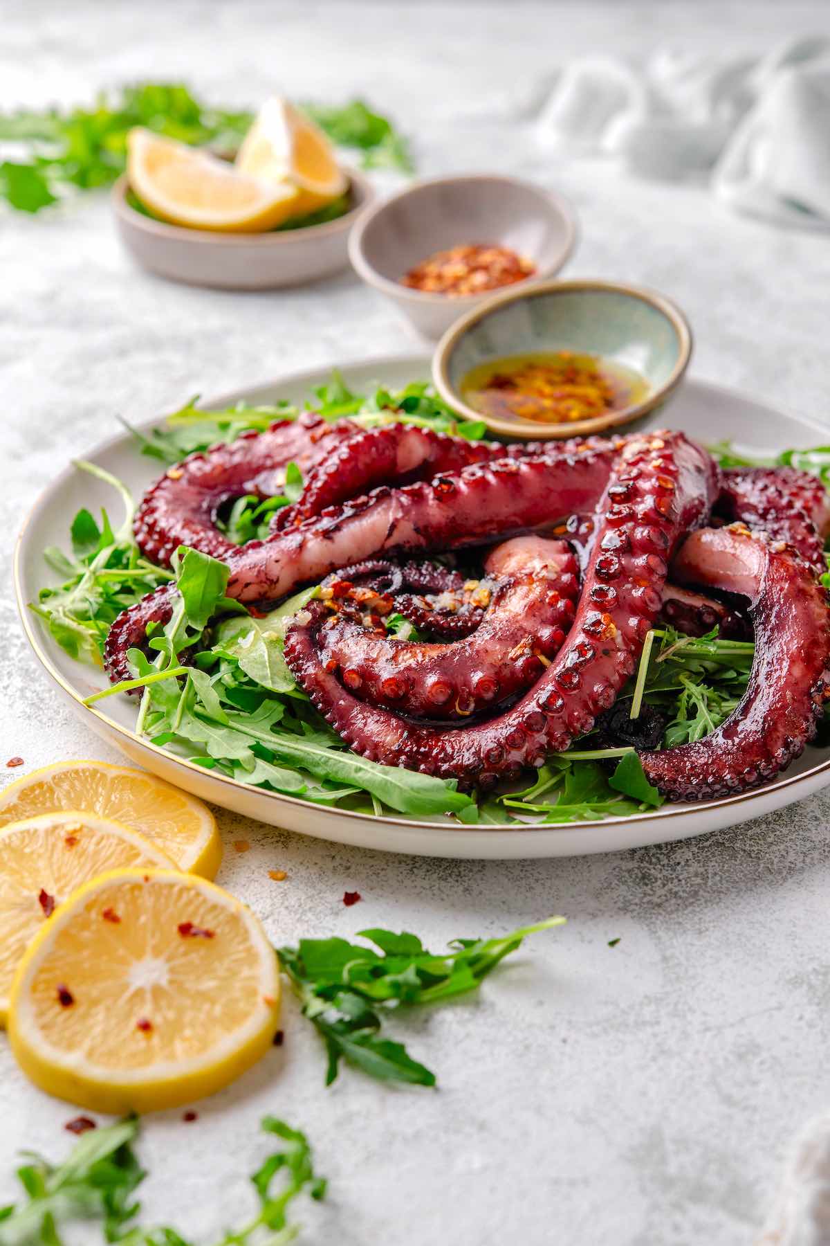 grilled octopus served on a plate with dipping sauce.