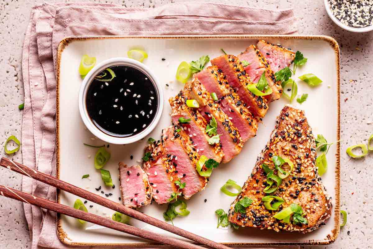 cooked and sliced ahi tuna with dipping sauce.