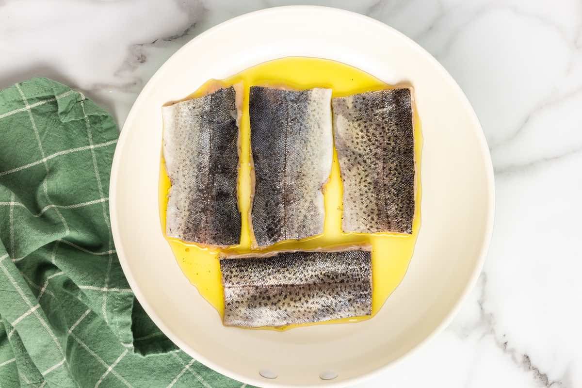 searing rainbow trout fillets in butter and oil.