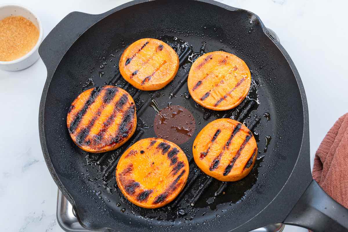 grilled sweet potato rounds in a grill pan.