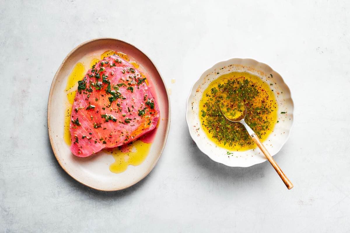 marinated raw tuna steak on a plate.