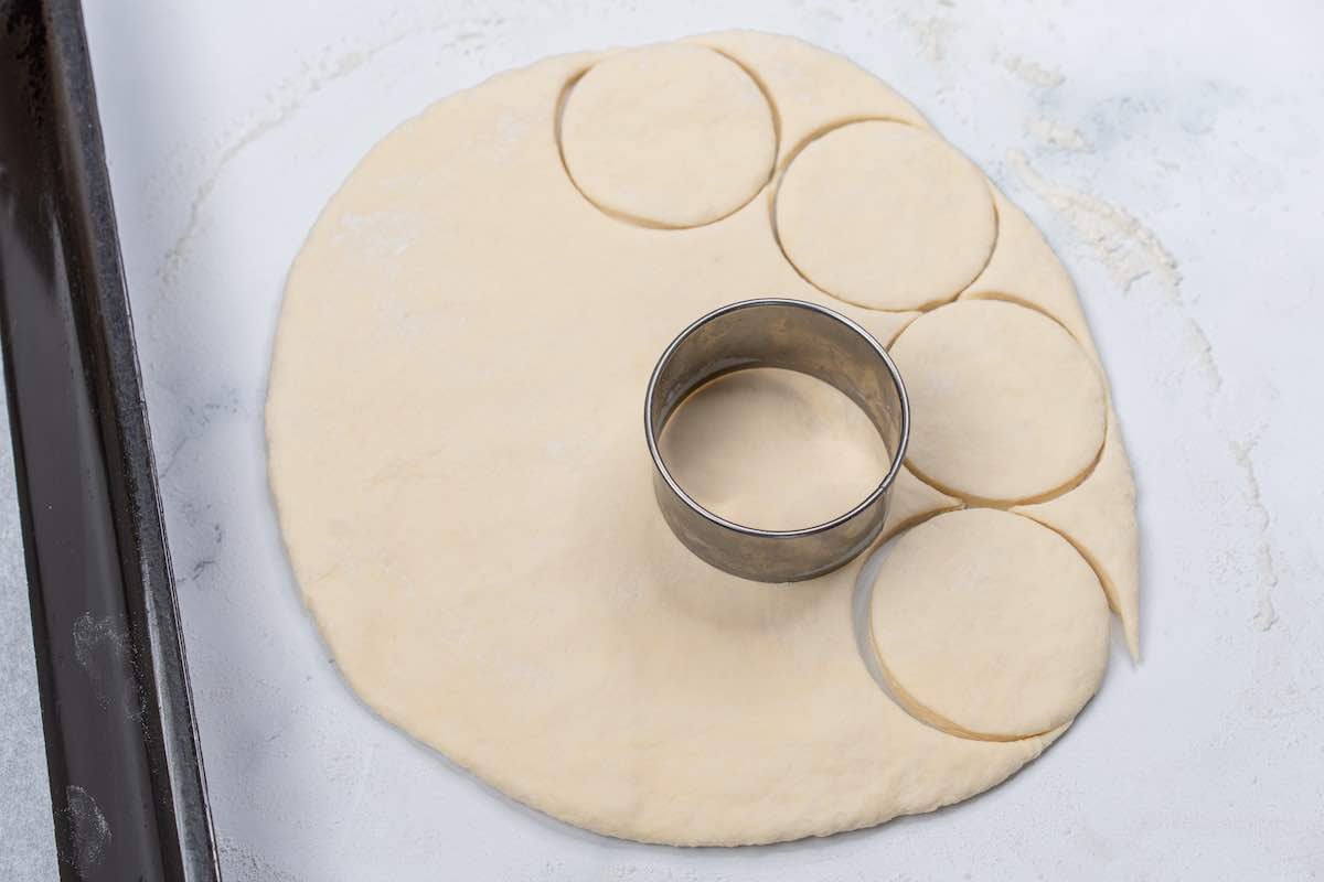 cutting out biscuits using a biscuit cutter.