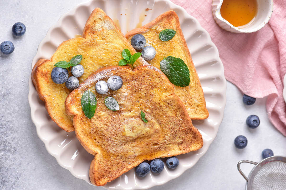 air fried french toast with fresh berries and powdered sugar.