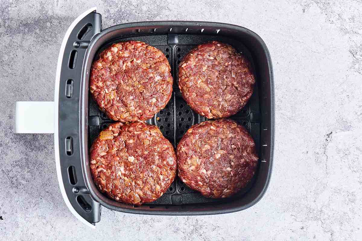 shaped hamburger patties in the air fryer basket.